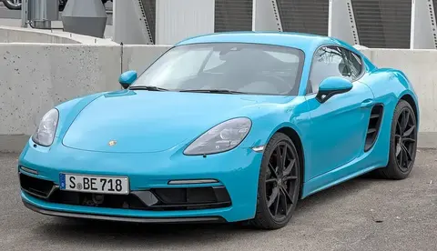 A Porsche 718 Cayman GTS 4.0 photographed side-on, the six-cylinder GTS that revived the flat-six in the Cayman line.