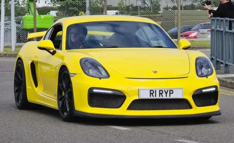 A Porsche 981 Cayman GT4 photographed outdoors, running the 991.1 Carrera S flat six rotated 180 degrees to sit ahead of the rear axle.