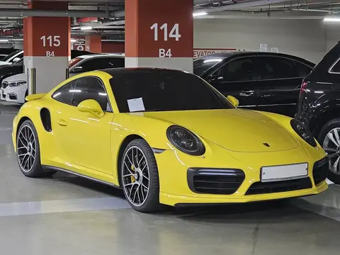 A yellow Porsche 991.2 911 Turbo S photographed outdoors, from the Exclusive Manufaktur era that produced the 500-unit Golden Yellow Metallic Exclusive Series.