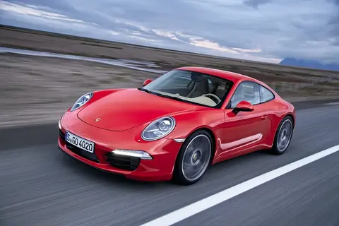 A 2012 Porsche 911 Carrera coupe (991.1) photographed outdoors, from the generation that switched to a part-aluminium bodyshell and a longer wheelbase.