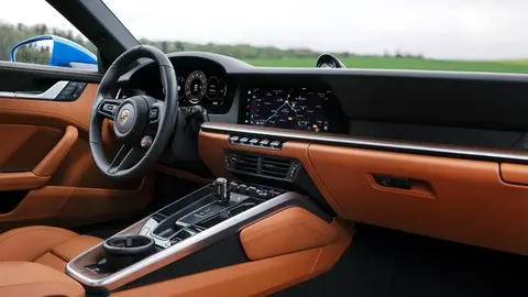 The digital dashboard of a facelifted 992.2 Porsche 911, showing the fully digital curved instrument display that replaced the car's analogue rev counter.