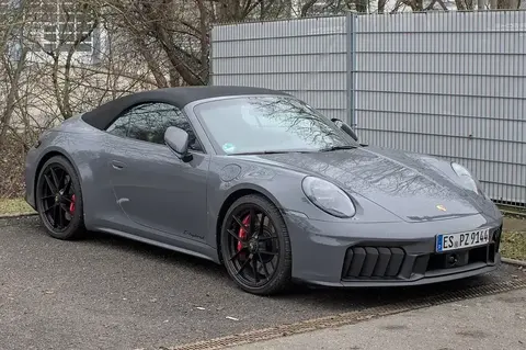 A Porsche 992.2 Carrera GTS Cabriolet with its T-Hybrid badge visible, the first hybrid-assisted 911 in the nameplate's history.