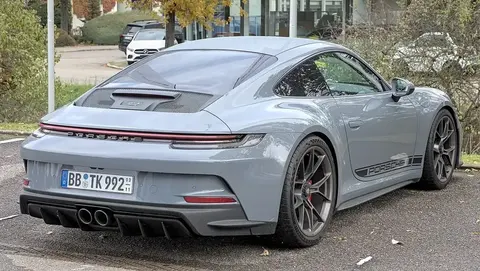 A Porsche 992 GT3 with the Touring package, shown in profile with its front suspension derived from the RSR racer.