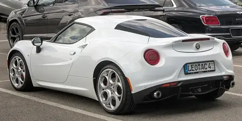 An Alfa Romeo 4C coupe shown side-on, built around the carbon-fibre passenger tub at the heart of the car.