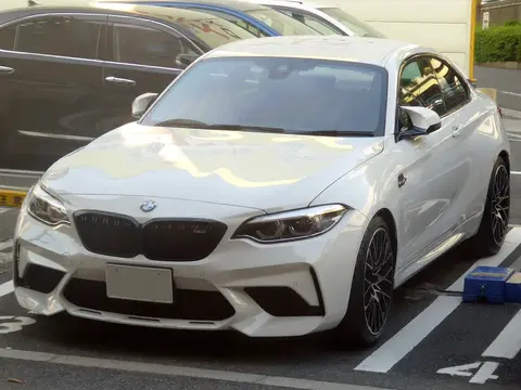 A BMW M2 Competition of the F87 generation photographed from the front, the version that received the M3 and M4's S55 engine.