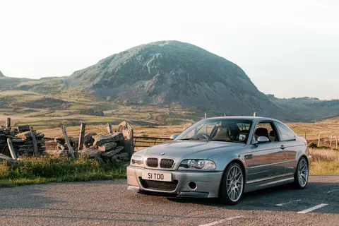 A BMW M3 CSL of the E46 generation photographed outdoors, the lightweight model sold only with the SMG II automated manual gearbox.