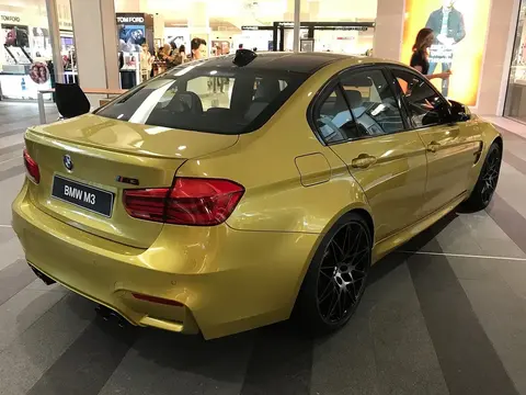 A BMW M3 F80 sedan in three-quarter view, the generation that introduced turbocharging to the M3 nameplate for the first time.