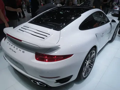 A Porsche 911 Turbo shown from the rear at the 2013 IAA motor show, the model that introduced Porsche's rear-axle steering system later offered on the Cayenne S.