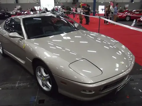 A Ferrari 456 GT parked outdoors, from the last Ferrari model line built with folding pop-up headlights.
