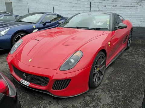 A Ferrari 599 GTO parked outdoors, the run-out variant that out-lapped Ferrari's own Enzo hypercar at Fiorano.