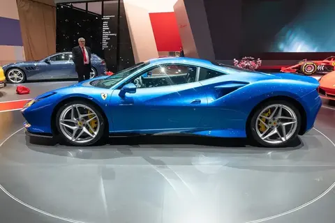 A Ferrari F8 Tributo at a motor show, powered by a development of the F154 V8 that won International Engine of the Year three times.