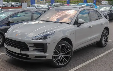 A facelifted Porsche Macan shown front-on, continuing the four-cylinder engine lineage.
