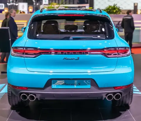 Direct rear view of a Miami Blue facelifted Porsche Macan S with quad exhaust tips, badged 'Macan S', at the 2019 Geneva Motor Show.