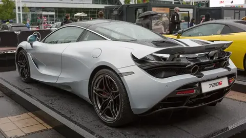 A grey McLaren 720S on display at the Frankfurt IAA motor show, shown from the rear three-quarter angle.