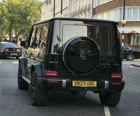 A black current-generation Mercedes-AMG G63, the same 2023-era G-Class generation as the 500,000th unit milestone car.