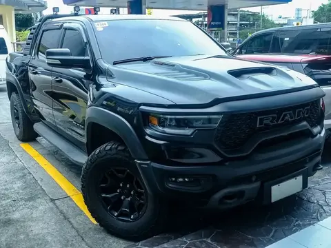 A black Ram 1500 TRX in Diamond Black Crystal paint, front three-quarter view.